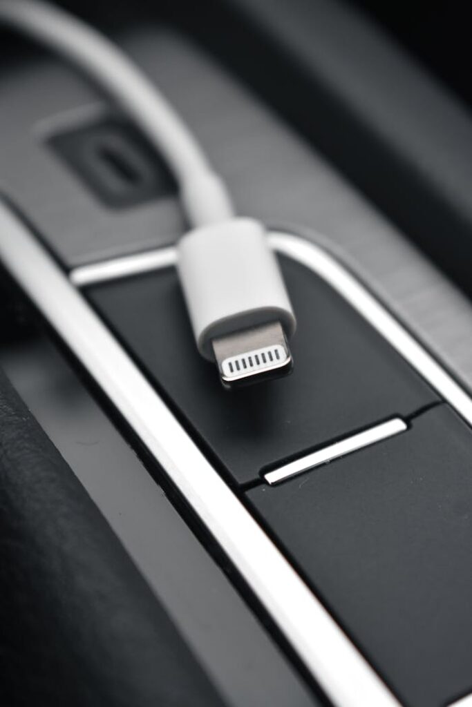 A detailed close-up image of a lightning connector against a sleek black surface, ideal for tech themes.